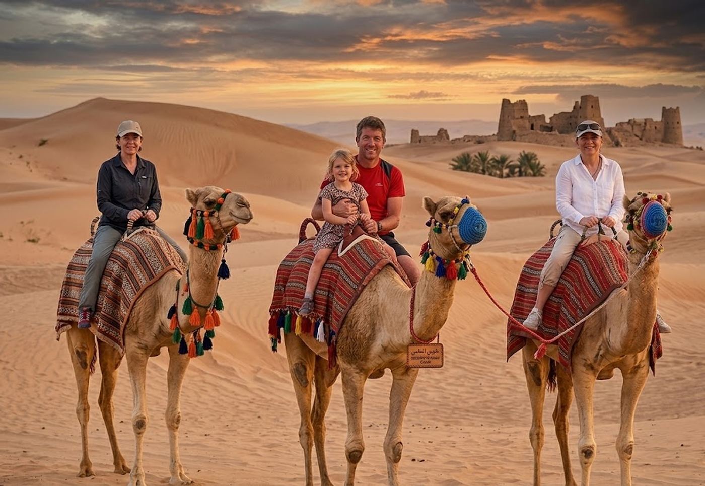 Camel riding in the desert at sunset
