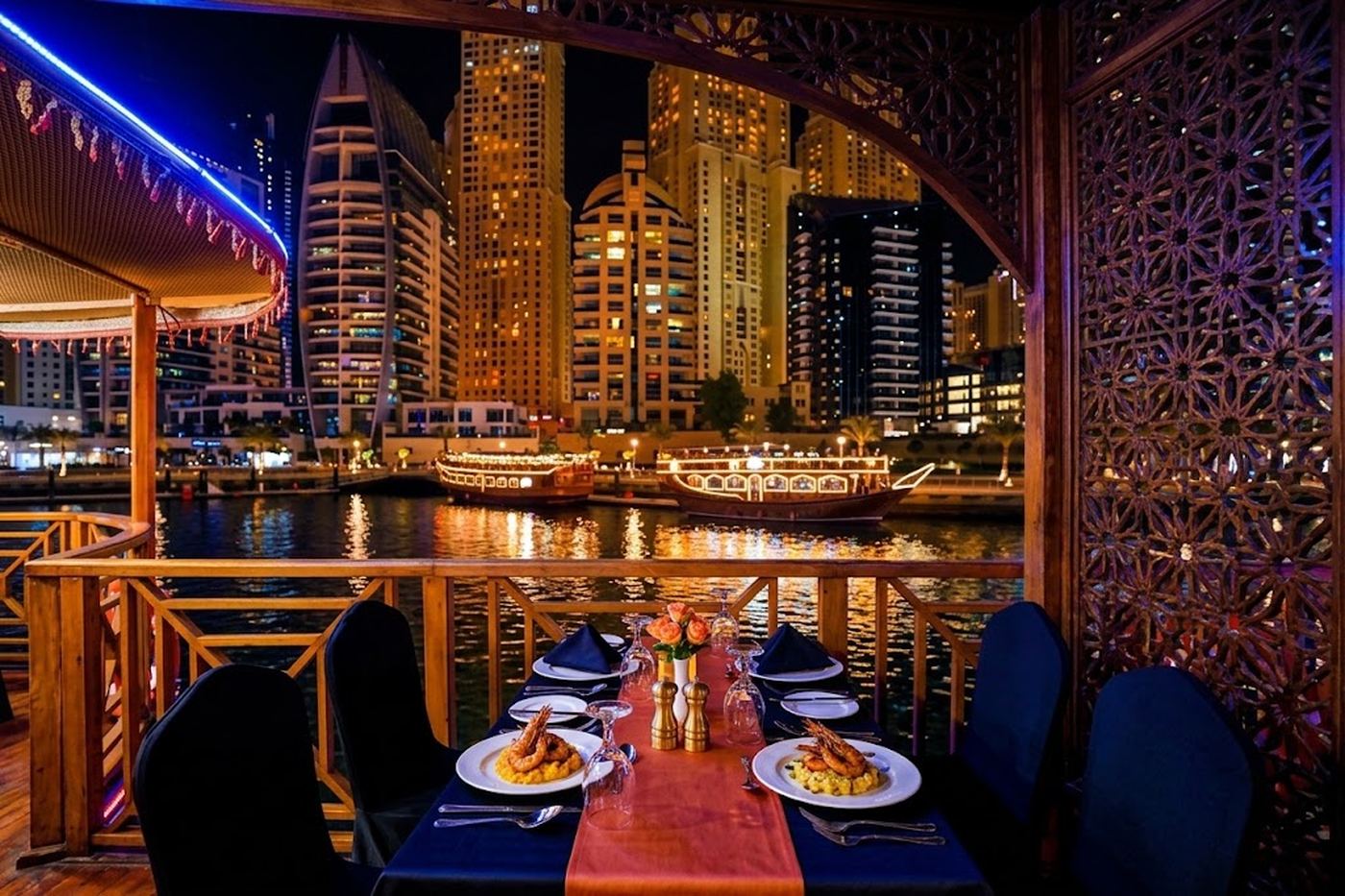Dinner table on a dhow cruise with Dubai Marina skyline view